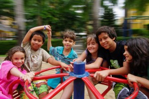 Kids laughing together on a merry-go-round