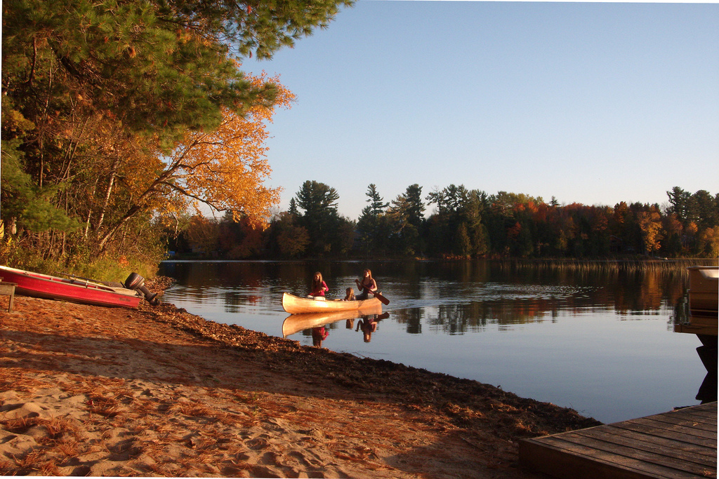 Girls in a canoe on a lake in Fall