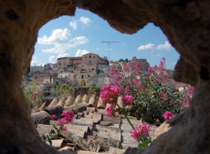 Village in spring through a hole in a rock