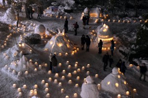 People walking through lit up snow sculptures