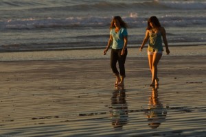 mother and daughter walking on the beach