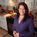 Heather Tallman takes a break from cooking to pose for a photo in her kitchen.